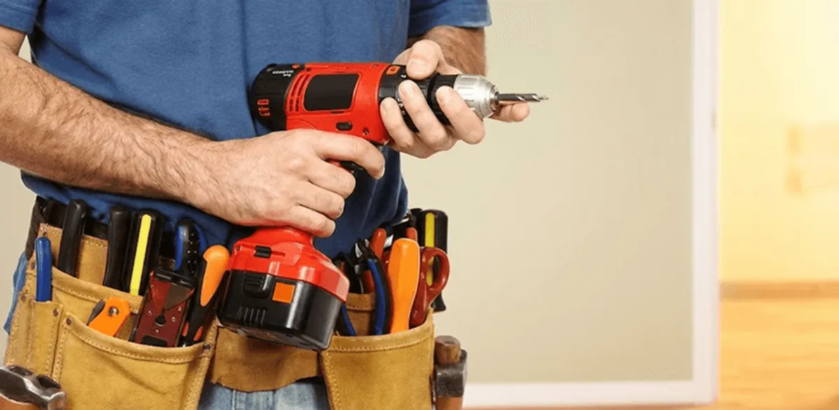 Handyman holding a power drill for home repairs and installations in Norfolk, VA